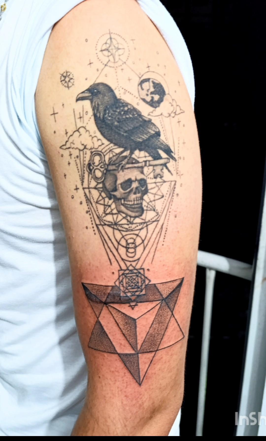 Crow and skull geometric tattoo
